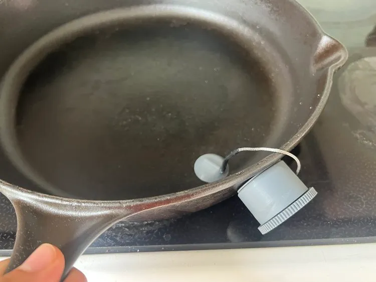 The probe magnetically attached to the underside of a cast-iron pan